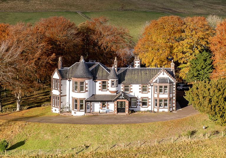 Exterior of Kinclune House with autumnal trees surrounding